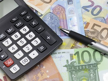 Taschenrechner und Kugelschreiber auf Eurobanknoten unterschiedlicher Werte - Nahaufnahme Taschenrechner und Kugelschreiber auf Eurobanknoten unterschiedlicher Werte - Nahaufnahme