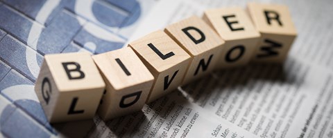 Sechs Holzwürfel auf einer Zeitung bilden das Wort „Bilder Sechs Holzwürfel auf einer Zeitung bilden das Wort „Bilder